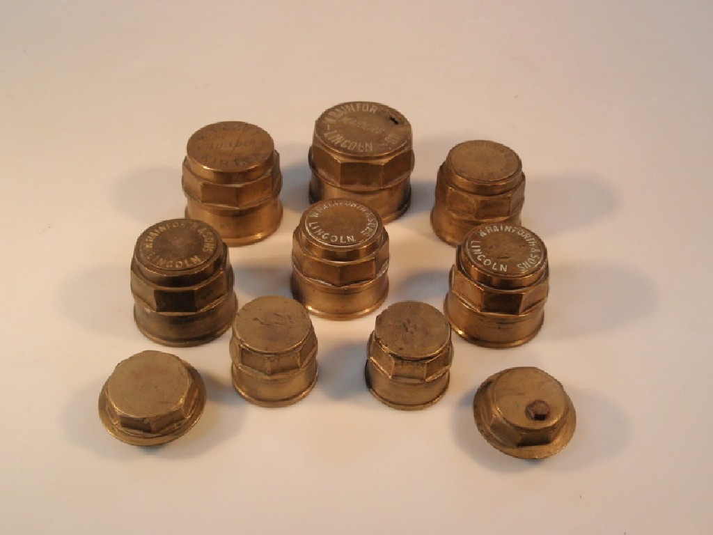 Appraisal: A quantity of brass cart hub covers including five marked