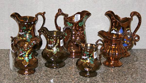 Appraisal: An assembled group of seven copper luster pitchers second half