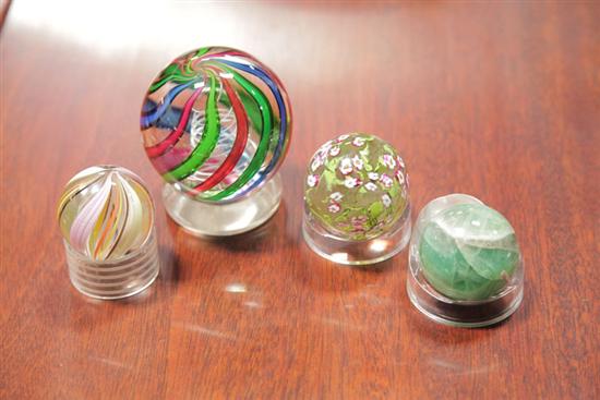 Appraisal: FOUR GLASS MARBLES Large marble with red green and blue