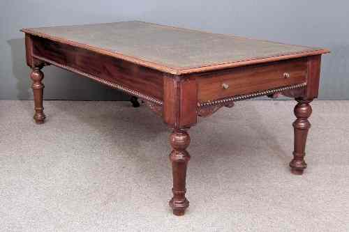 Appraisal: A Victorian mahogany library table with green leather inset to