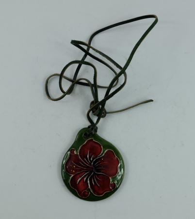 Appraisal: Moorcroft pendant decorated in the hibiscus design with green leather