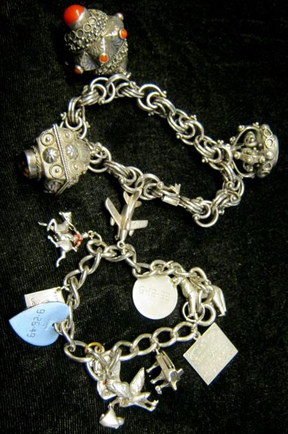 Appraisal: Double sterling silver charm braceletsCharms varying in size and shape