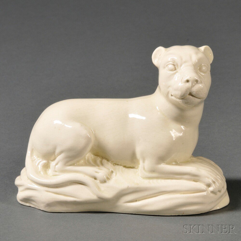 Appraisal: Staffordshire Cream-colored Earthenware Model of a Recumbent Lioness England c