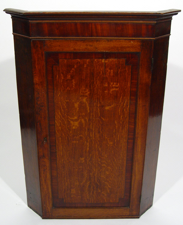 Appraisal: th Century crossbanded mahogany and oak corner cabinet the moulded