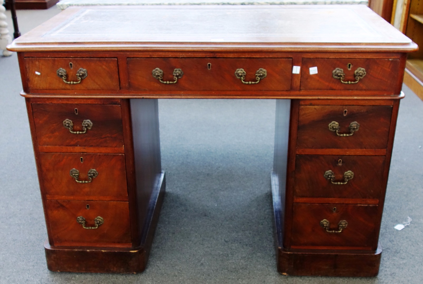 Appraisal: A Victorian walnut pedestal desk with nine drawers about the