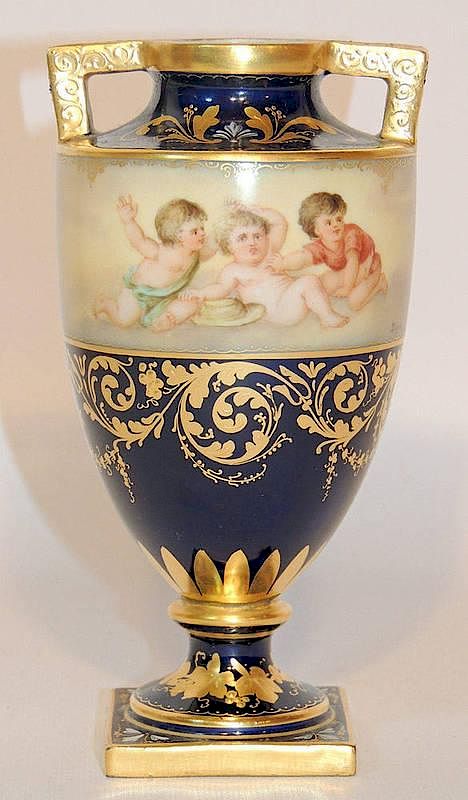 Appraisal: Royal Vienna Porcelain Urn With a cupid-decorated panel on cobalt