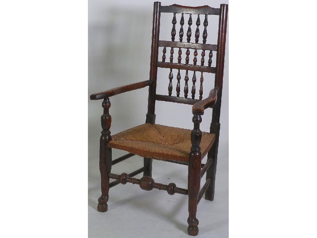 Appraisal: TH CENTURY ELM SPINDLE BACK OPEN ARMCHAIR the shaped top