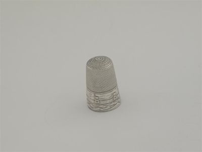 Appraisal: A Victorian thimble stamped with a view of a chain