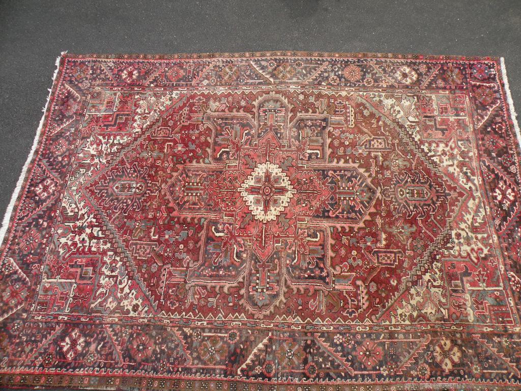 Appraisal: A large Persian carpet with a central medallion on a