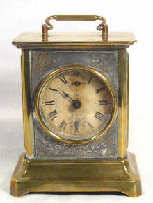 Appraisal: A brass cased travelling alarm clock by Junghans cm high