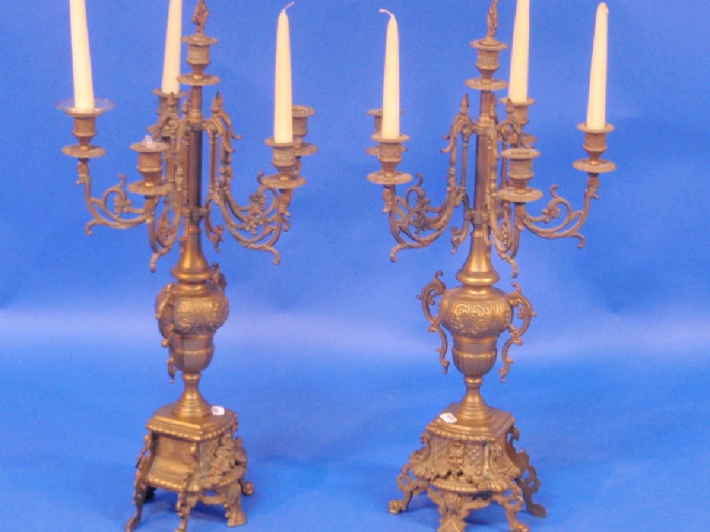 Appraisal: A pair of ornate cast brass candelabra each with five