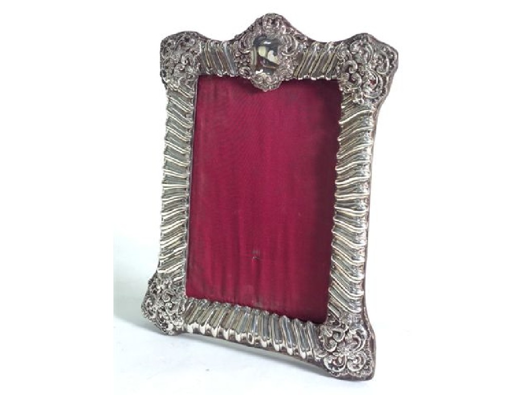 Appraisal: EDWARDIAN SILVER PHOTOGRAPH FRAME H MATTHEWS BIRMINGHAM of shaped rectangular