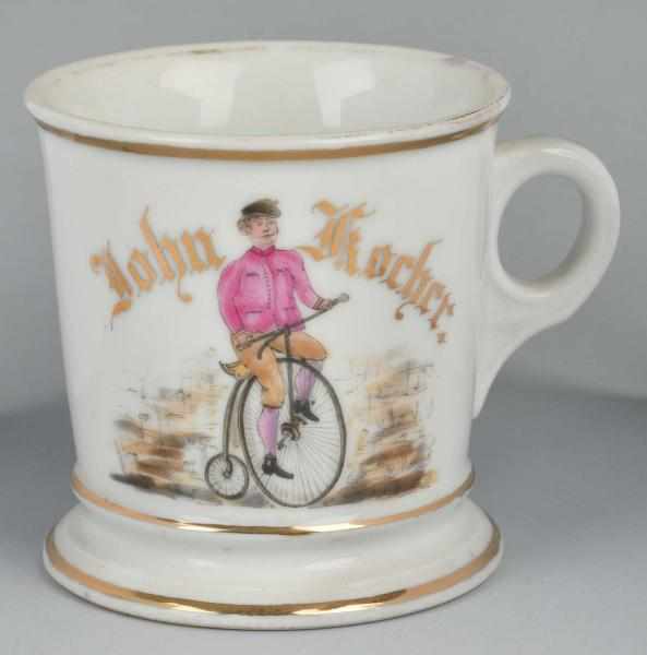 Appraisal: High Wheel Bicycle Shaving Mug Description Gilt name John Kocher