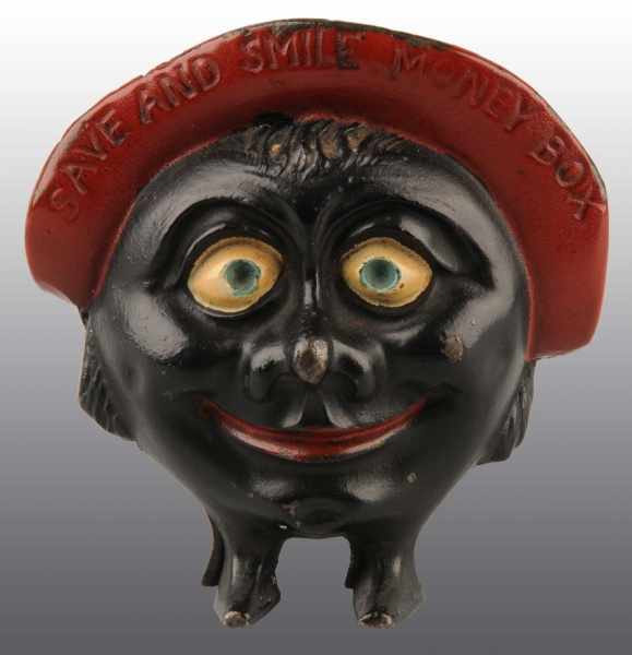 Appraisal: Cast Iron Save Smile Still Bank Description Manufactured by Chamberlin