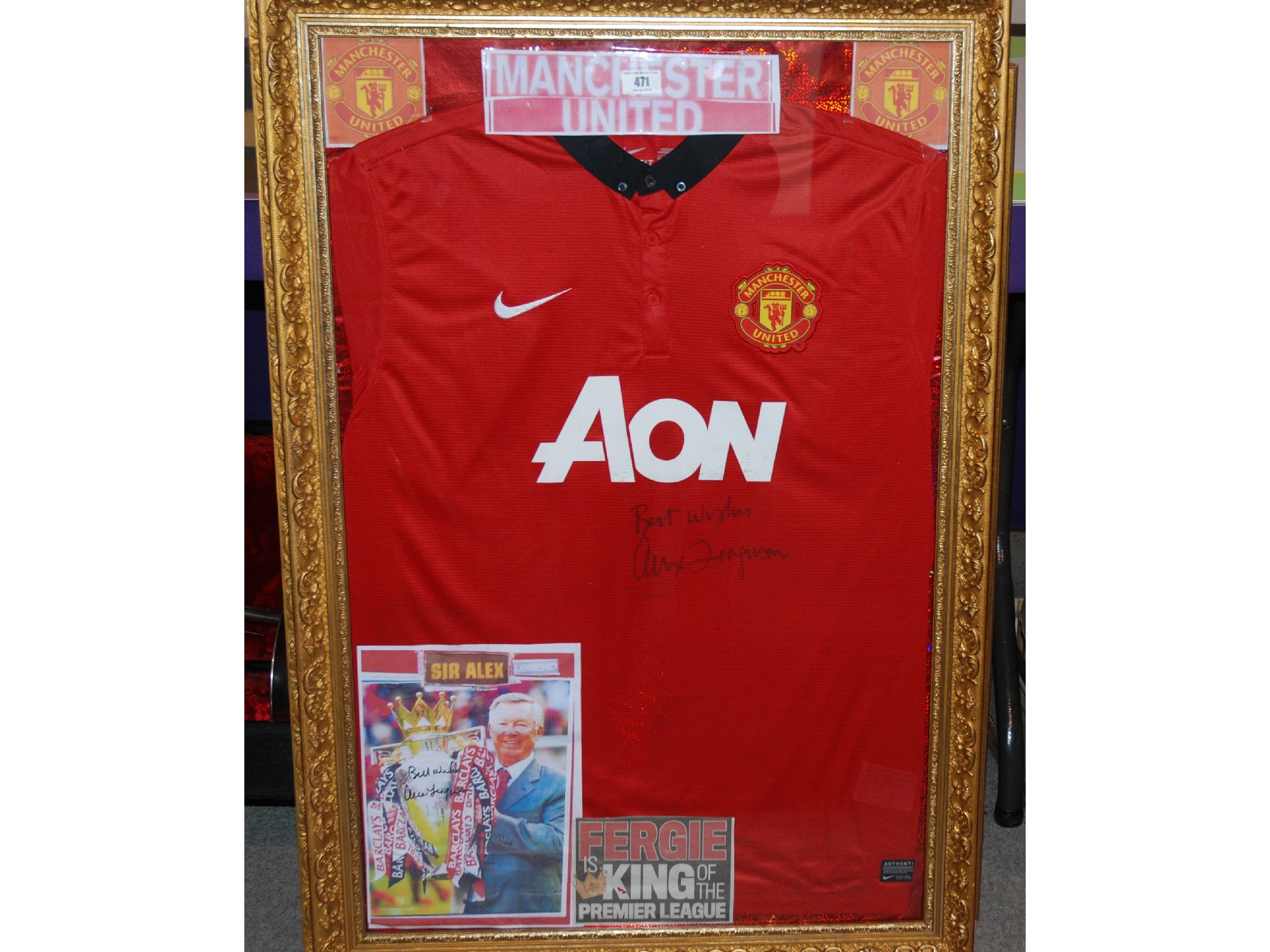 Appraisal: A red Manchester United replica shirt autographed by Alex Ferguson