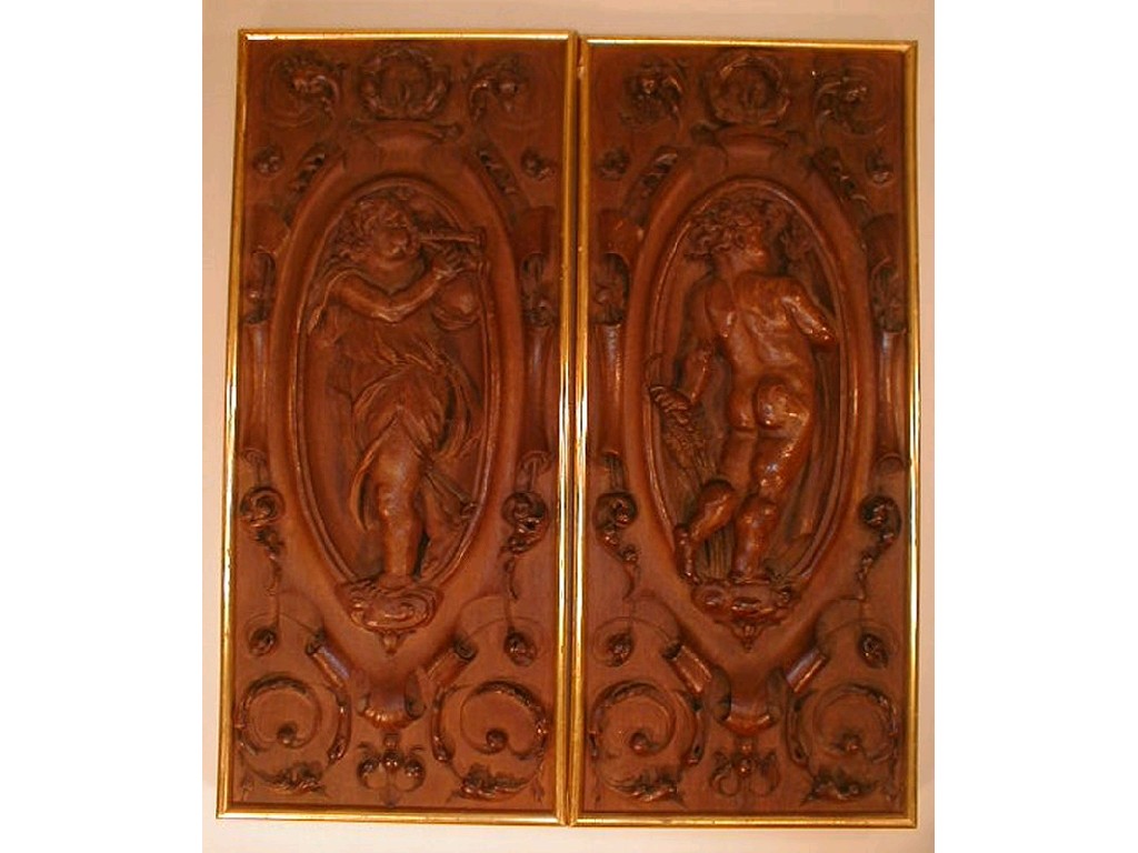 Appraisal: A pair of thC carved oak panels depicting cherubs with