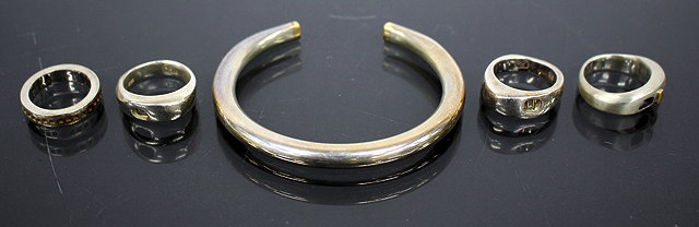 Appraisal: A SILVER BRACELET four designer silver rings acquired from Justice