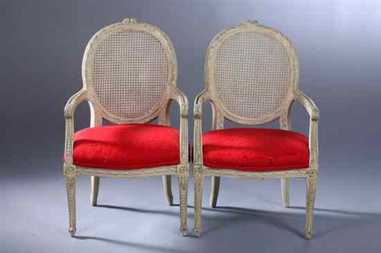 Appraisal: PAIR LOUIS XVI STYLE CREAM-PAINTED CHILD'S FAUTEUILS th century Having