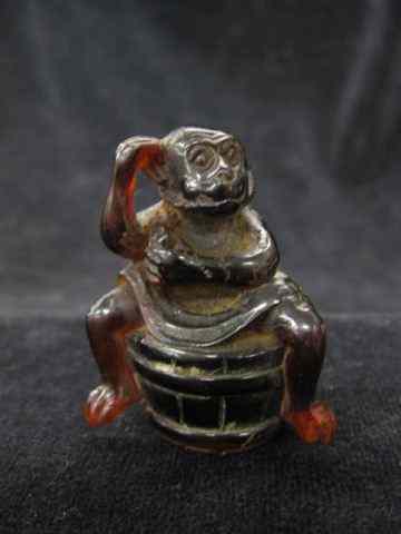 Appraisal: Carved Amber Figurine of Monkey on aWashtub '' excellent