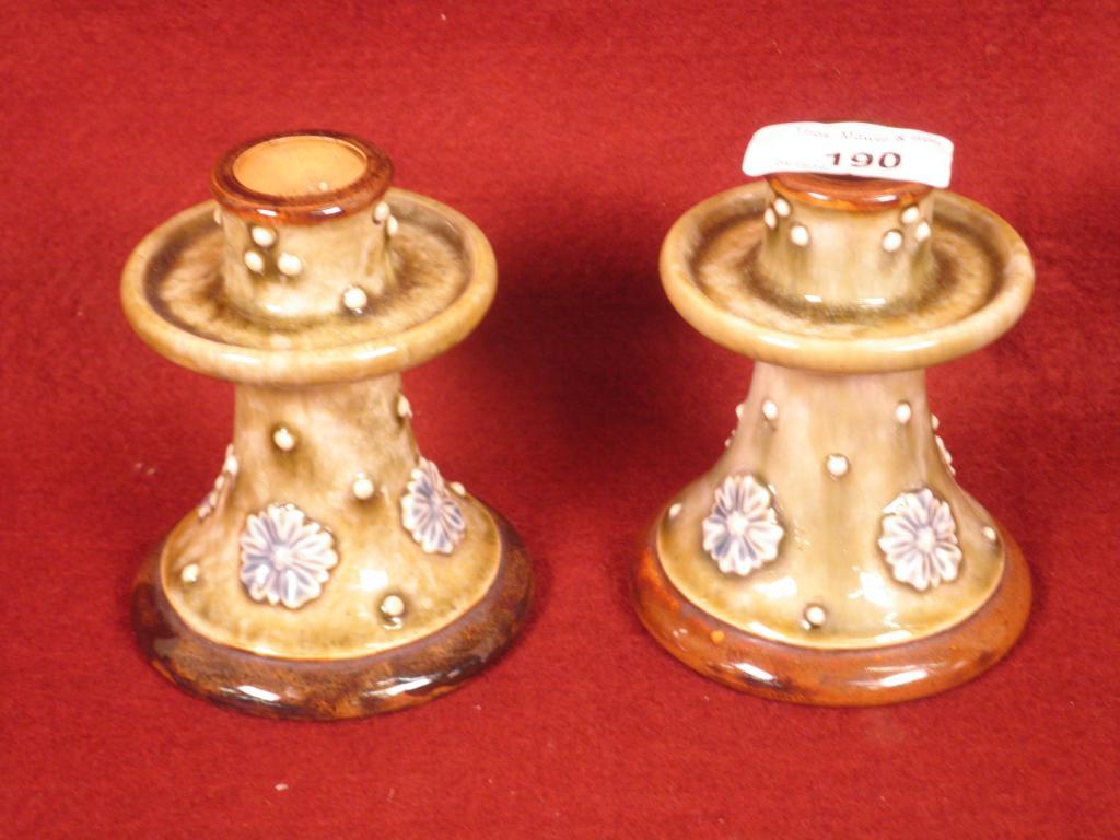 Appraisal: A pair of Royal Doulton stoneware candlesticks each decorted with