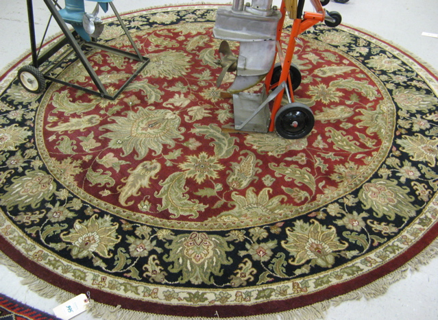 Appraisal: ROUND ORIENTAL CARPET Indo-Persian overall floral design on red ground