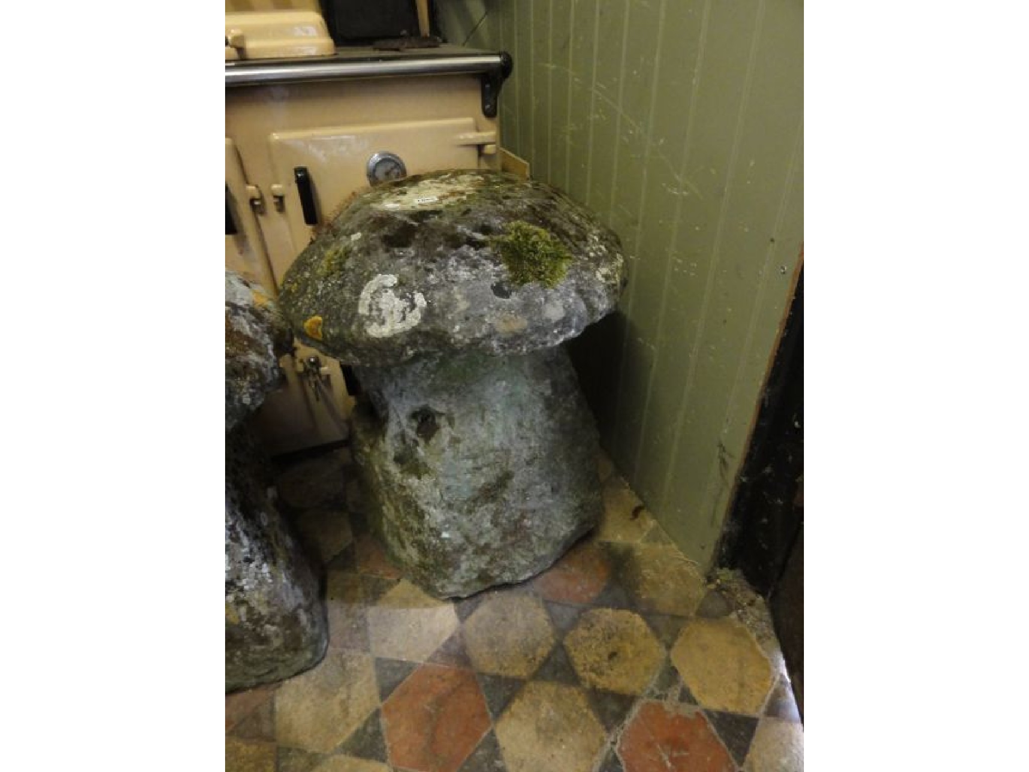 Appraisal: A weathered natural stone staddle stone and domed cap