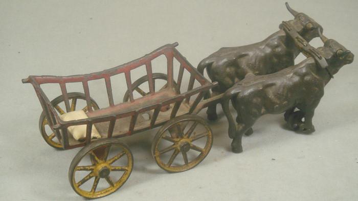 Appraisal: Cast iron toy double steer drawn open utility cart with