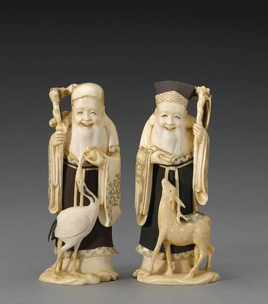 Appraisal: Two polychromed ivory figural okimono Showa Period Featuring the Chinese