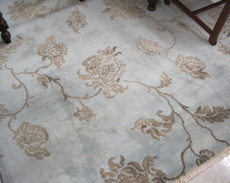 Appraisal: HAND KNOTTED ORIENTAL CARPET overall floral pattern in taupe silhouette