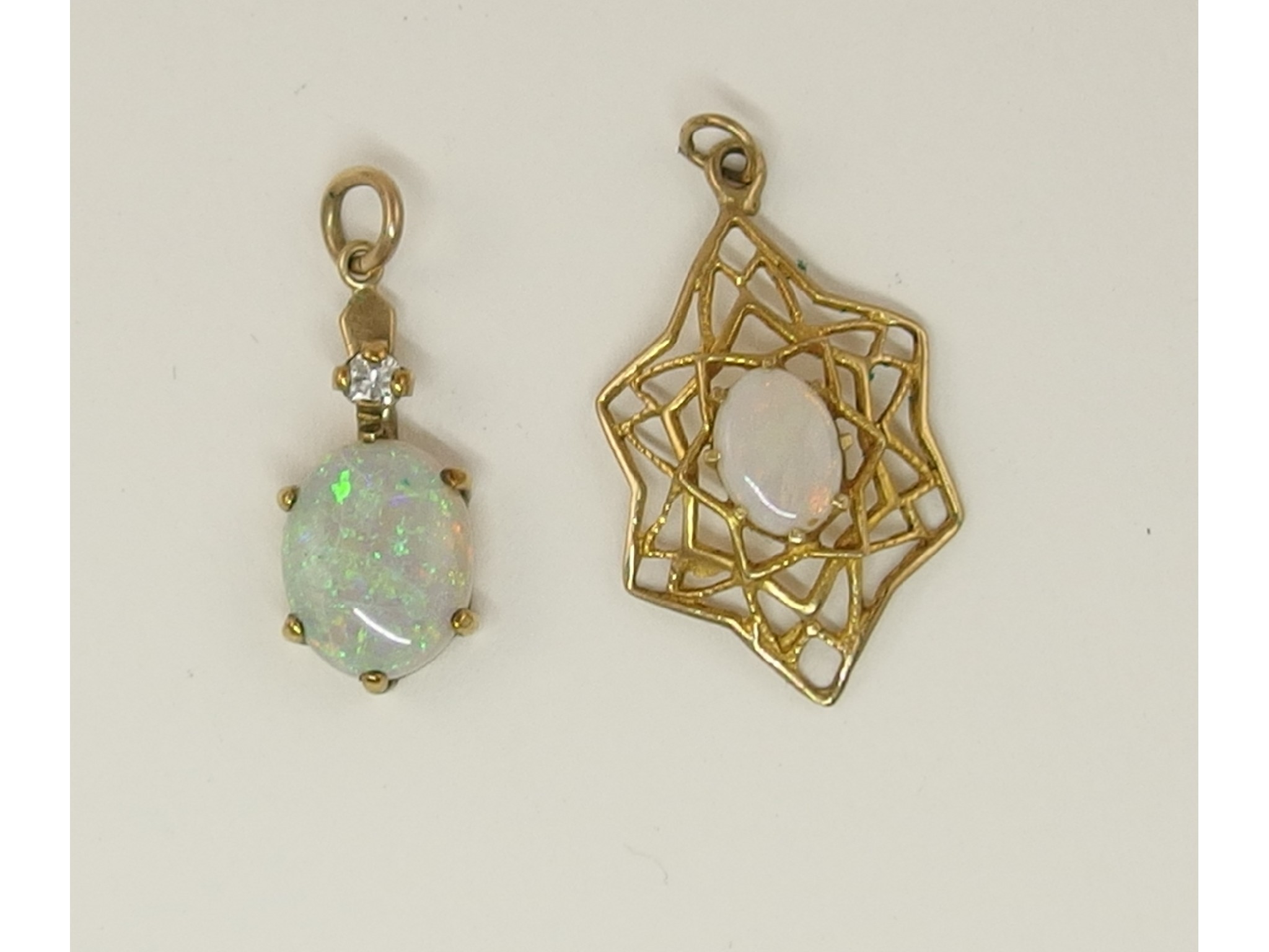 Appraisal: Two ct opal set pendants one with a diamond