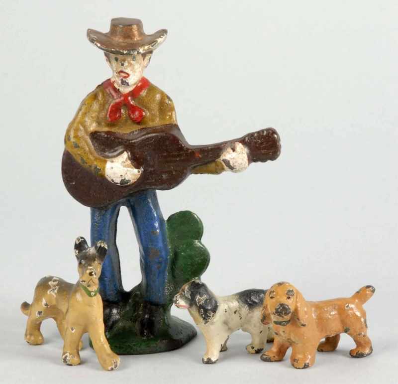 Appraisal: Lot of Cast Iron Figural Pieces Description Includes cowboy playing