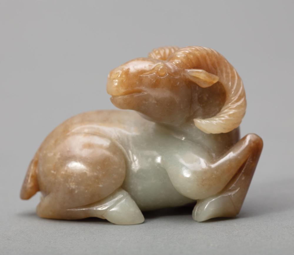 Appraisal: Chinese Green and Russet Jade Ram carved recumbent with head