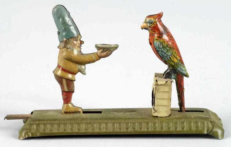 Appraisal: Tin Litho Gnome Parrot Penny Toy Description German Marked Gesch