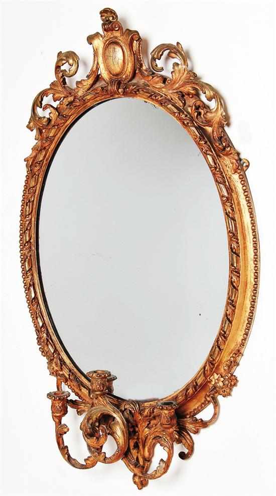 Appraisal: Rococo style giltwood girandole mirror mid th century oval leaf-carved