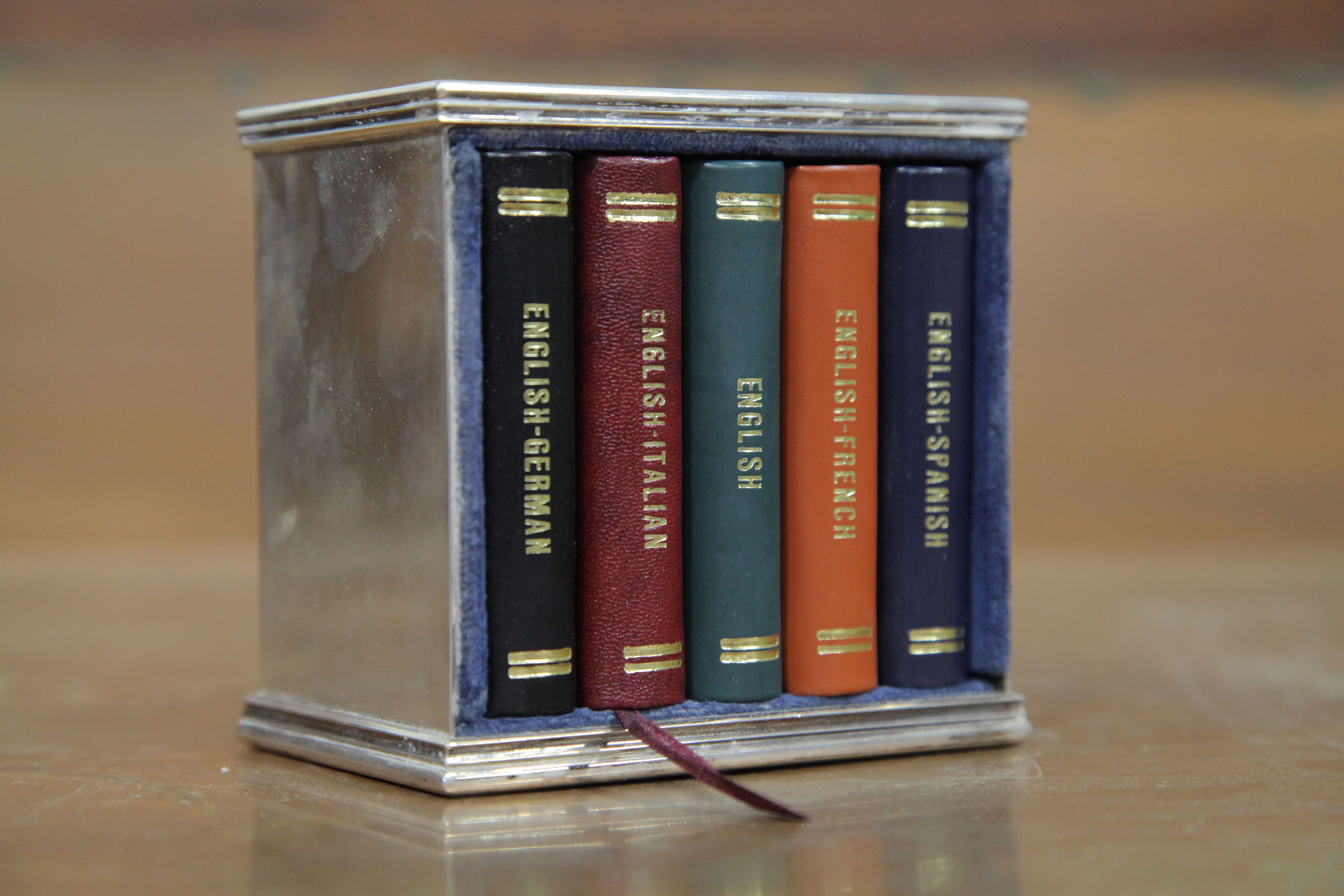 Appraisal: SET OF FIVE MINIATURE LANGUAGE TRANSLATOR BOOKS IN A STERLING