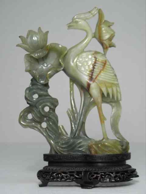 Appraisal: Chinese green and russet carved jade figure of a bird