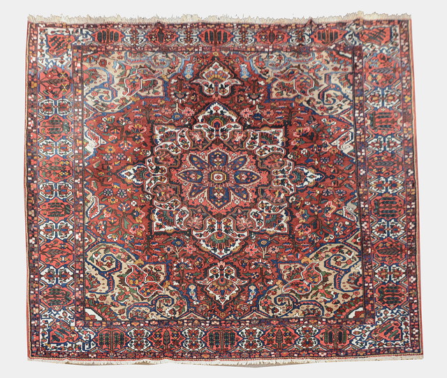 Appraisal: A BAKTIARI RED GROUND CARPET decorated a central rose medallion