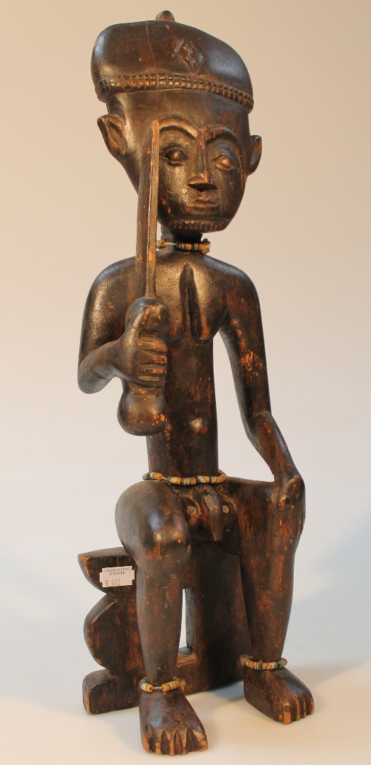 Appraisal: An thC African tribal figure of a nude male seated