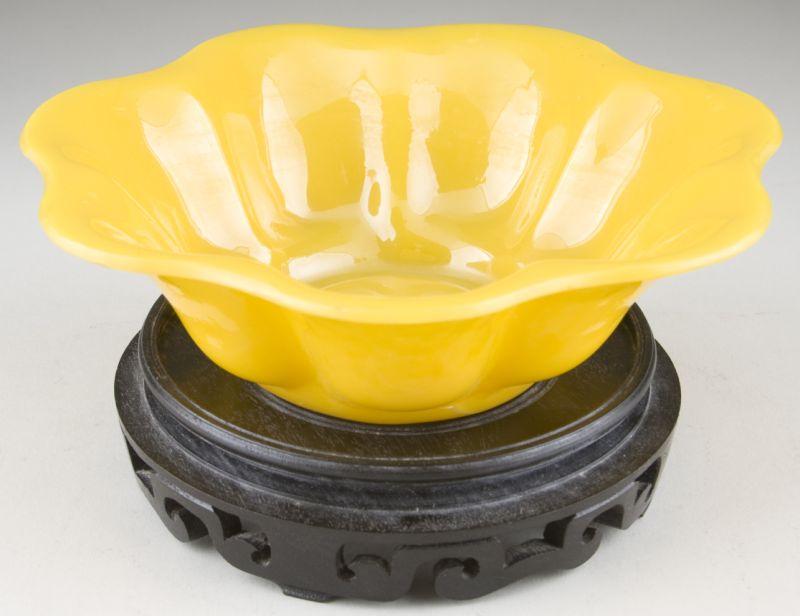 Appraisal: Peking Glass Carved Yellow Bowl having a scalloped rim and