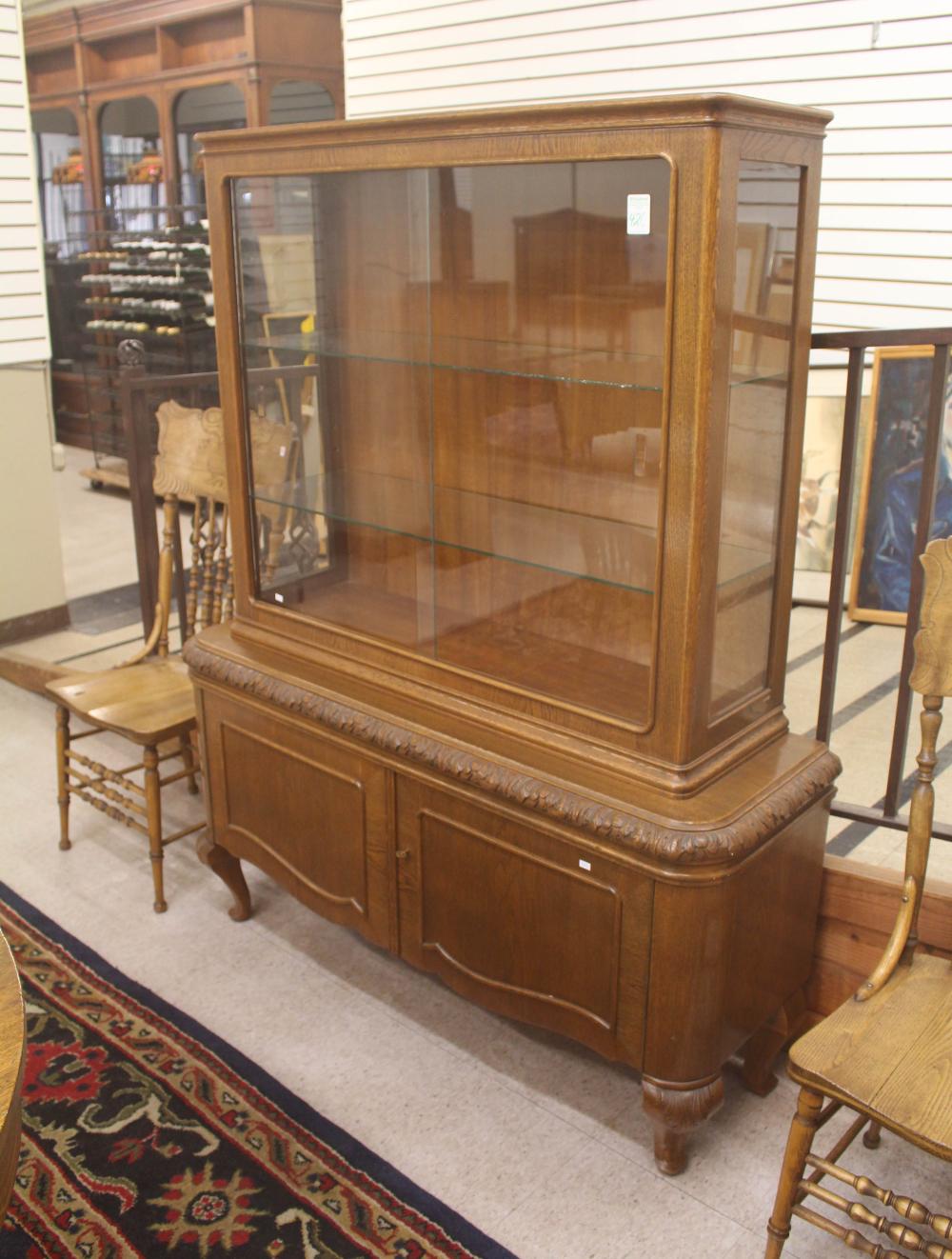 Appraisal: AN OAK AND GLASS CHINA CABINET ON CABINET German early