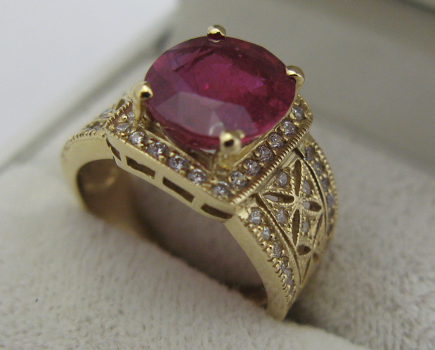 Appraisal: RUBY DIAMOND AND K GOLD RING round-cut diamonds surround an