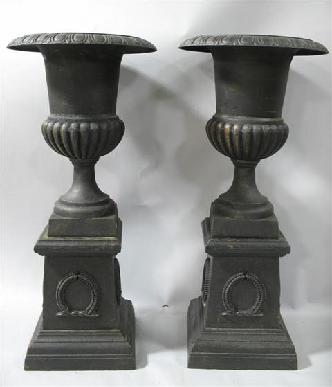 Appraisal: PAIR OF BLACK PAINTED CAST IRON URNS WITH BASES The