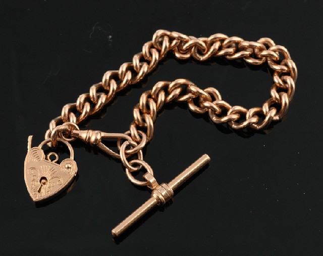 Appraisal: A gold padlock bracelet The ct gold curb link bracelet