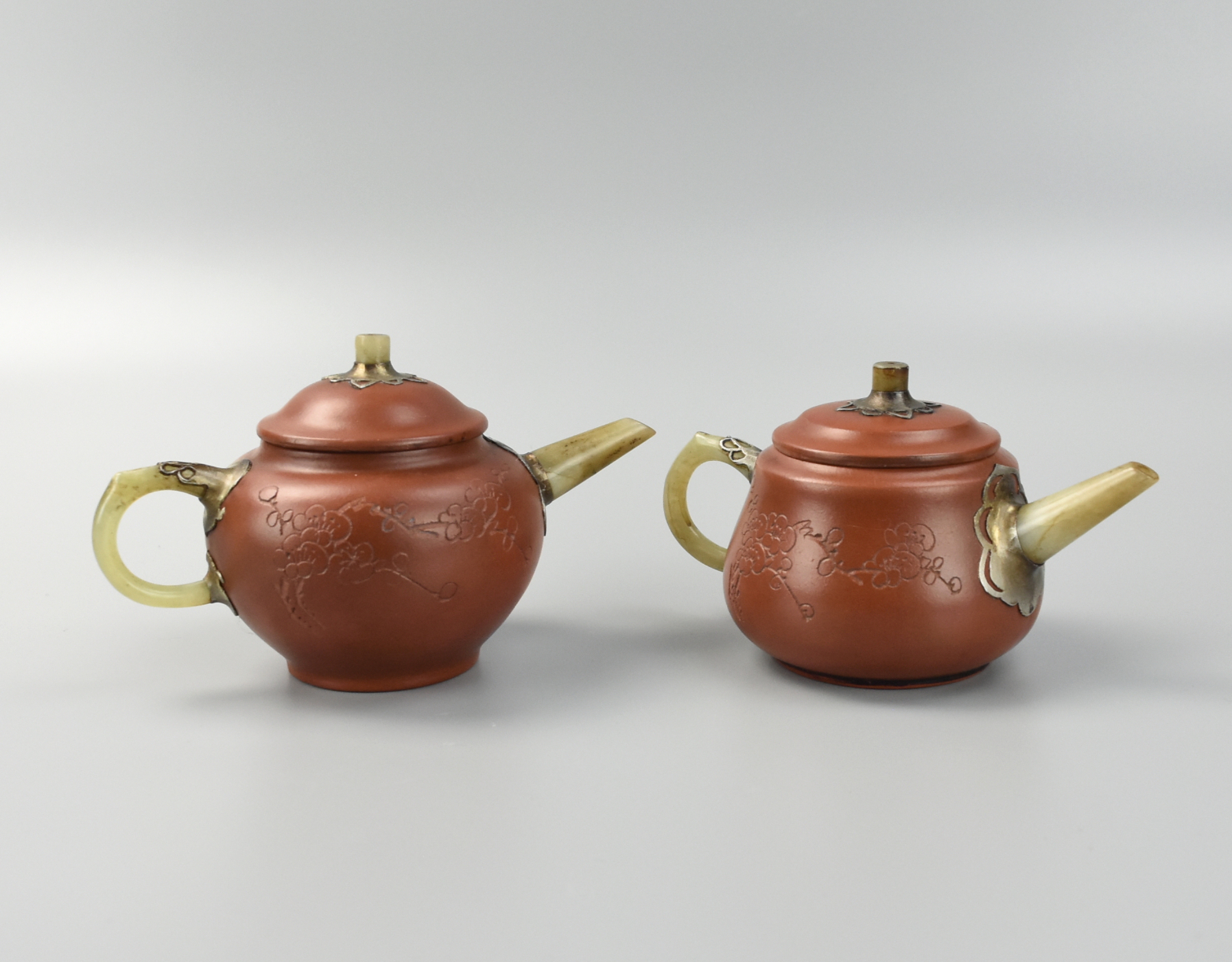 Appraisal: TWO CHINES ZHISHA TEAPOTS W JADE HANDLE SPOUT two Chinese