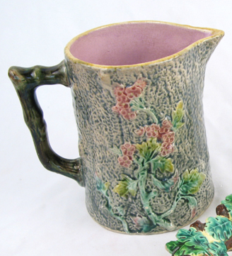 Appraisal: A MAJOLICA GLAZED POTTERY PITCHER multi-colored flower and leaf decoration