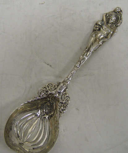 Appraisal: STERLING SILVER PIERCED SERVING SPOON Chased handle in Art Nouveau