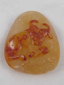 Appraisal: A hardstone pendant cameo of a bull resting amidst clouds