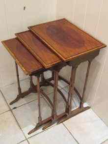 Appraisal: A trio of Edwardian nesting tables with oval frame mahogany