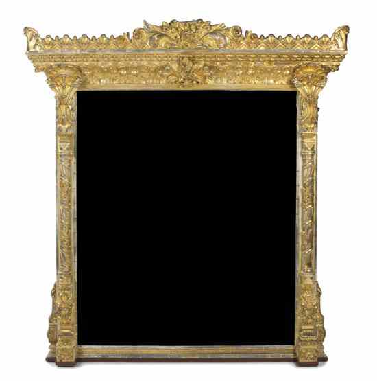 Appraisal: A Continental Giltwood Overmantel Mirror having a rectangular beveled plate