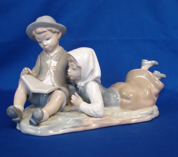 Appraisal: Nao by Lladro - Boy and Girl Reading Good Condition